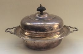 An unusual silver muffin dish and cover with match