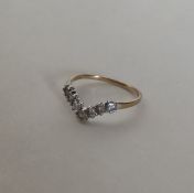 A 9 carat wishbone cluster ring. Approx. 1.5 grams