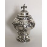 An unusual George II silver embossed tea caddy wit