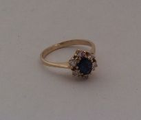 An 18 carat sapphire and diamond cluster ring. App