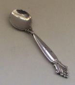 GEORG JENSEN: A stylish silver salt spoon of typic