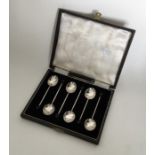 A boxed set of six silver bean top coffee spoons.