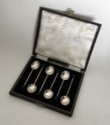 A boxed set of six silver bean top coffee spoons.