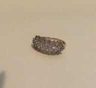 A 9 carat diamond circular cluster ring in claw mo