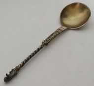 A Continental silver gilt spoon with twisted stem.