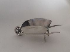 A novelty model of a wheelbarrow with dome mounts