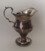 A Georgian style Edwardian silver cream jug with g
