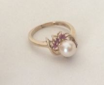 a cultured pearl and ruby seven stone ring. Approx