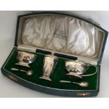 A cased silver three piece cruet. London. By Golds