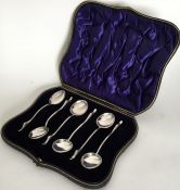 A boxed set of silver mounted teaspoons with duck