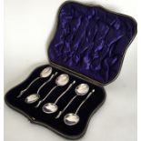 A boxed set of silver mounted teaspoons with duck