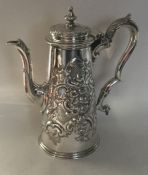A heavy tapering silver embossed coffee pot profus