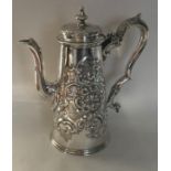 A heavy tapering silver embossed coffee pot profus