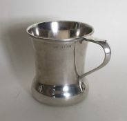 A small Edwardian plain silver mug on flat bottom.