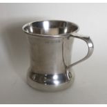 A small Edwardian plain silver mug on flat bottom.