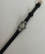 An attractive lady's diamond mounted cocktail watc