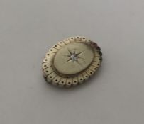 A Victorian gold oval target brooch with central d