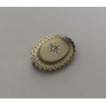 A Victorian gold oval target brooch with central d