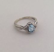 A 9 carat blue stone and diamond ring. Approx. 3 g