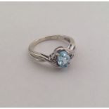 A 9 carat blue stone and diamond ring. Approx. 3 g