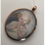 An attractive gold framed miniature of a child wit