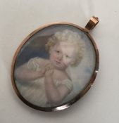 An attractive gold framed miniature of a child wit