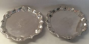 A good pair of silver salvers with crested centres
