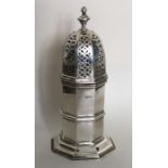 A tall silver sugar caster on spreading base. Ches