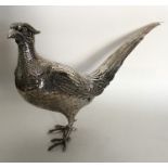 A large German silver model of a pheasant in stand