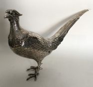 A large German silver model of a pheasant in stand