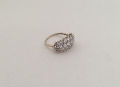 A large 9 carat three row ring in claw mount. Appr