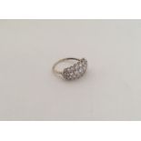 A large 9 carat three row ring in claw mount. Appr