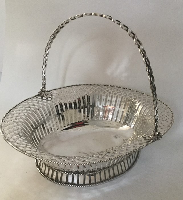 A George II silver cake basket with reeded body. L