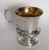 A campana shaped silver christening cup decorated