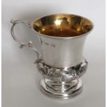 A campana shaped silver christening cup decorated