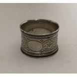 An Edwardian silver attractively engraved napkin r