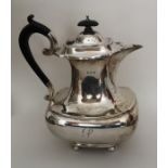 A stylish silver hot water pot of baluster form on