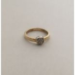 A circular 14 carat gold diamond cluster ring. App