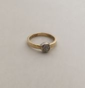 A circular 14 carat gold diamond cluster ring. App