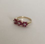 A ruby and diamond triple cluster ring in 9 carat