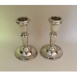A pair of modern silver tapering candlesticks with