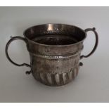 An early George I silver porringer with fluted bod