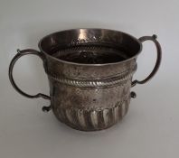 An early George I silver porringer with fluted bod