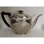 A large silver half fluted teapot with reeded deco