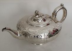 A good quality embossed Victorian silver teapot. L