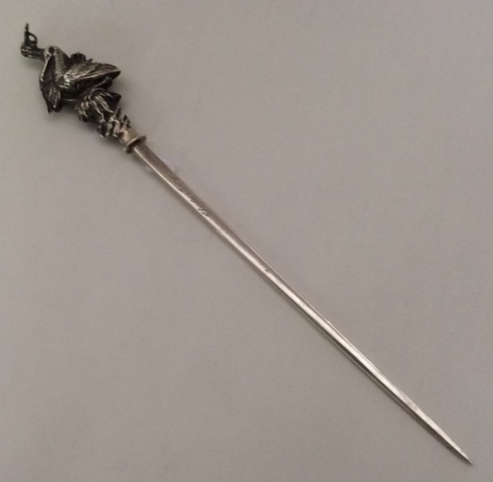 A French silver meat skewer decorated with nesting