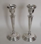 A tall pair of tapering circular silver candlestic