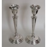 A tall pair of tapering circular silver candlestic