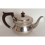 A circular silver bachelor's teapot with hinged to