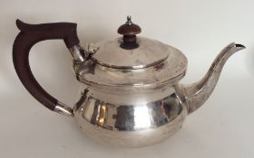 A circular silver bachelor's teapot with hinged to